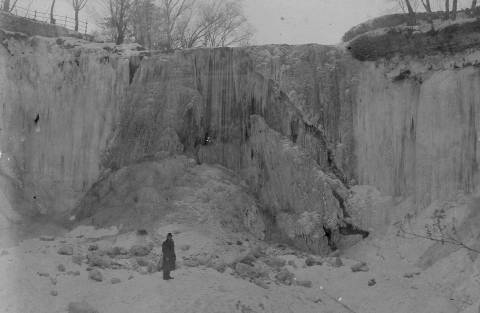 An unknown man staqnds at the foot of Minnehaha Falls in January, 1899. (Photo courtesy Edward Tobin Thompson)